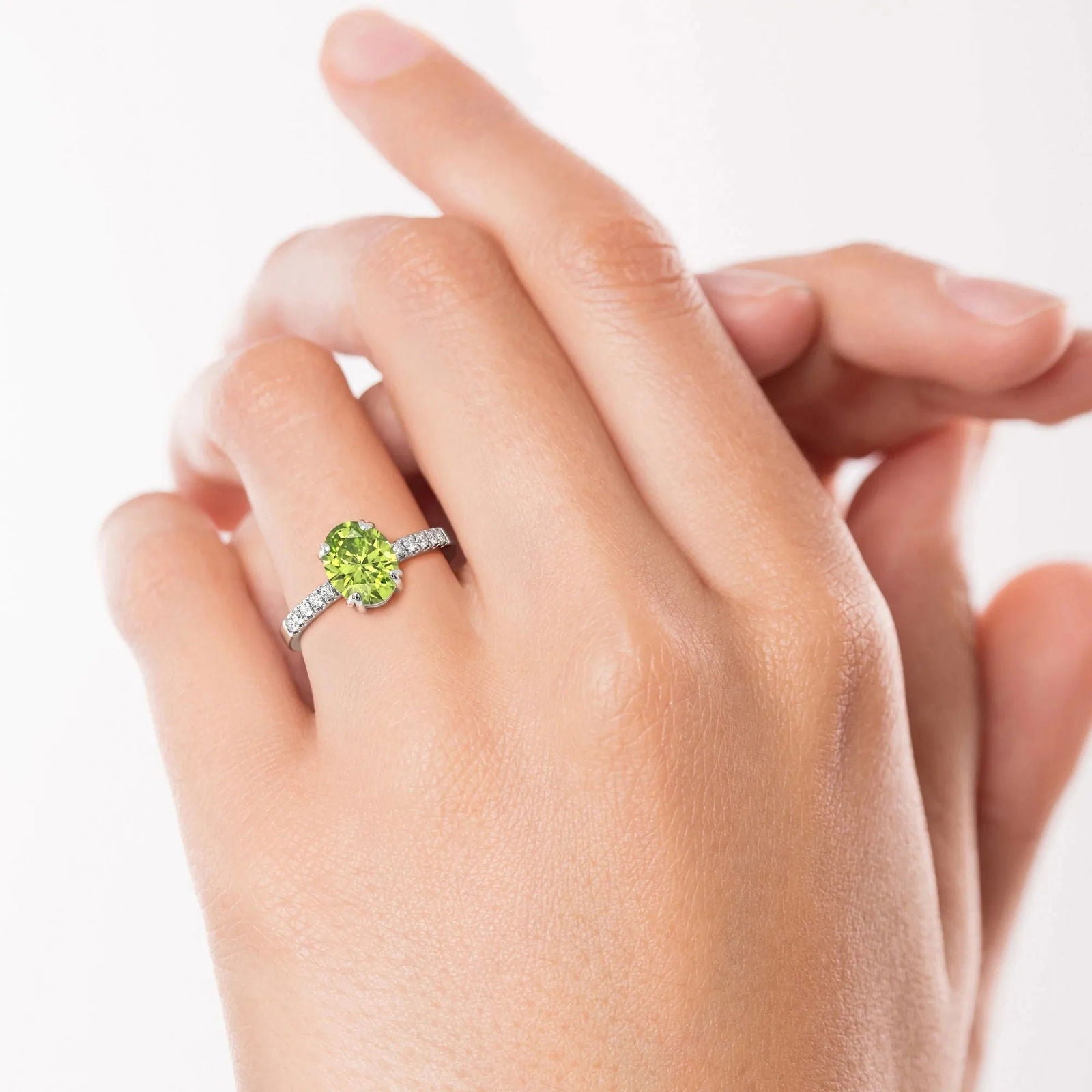 Model wearing Oval Peridot Silver Ring with Halo Design