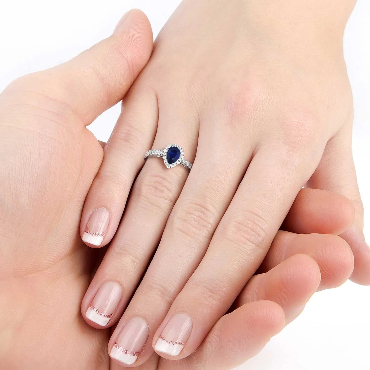 Pear cut sapphire ring with CZ halo accents