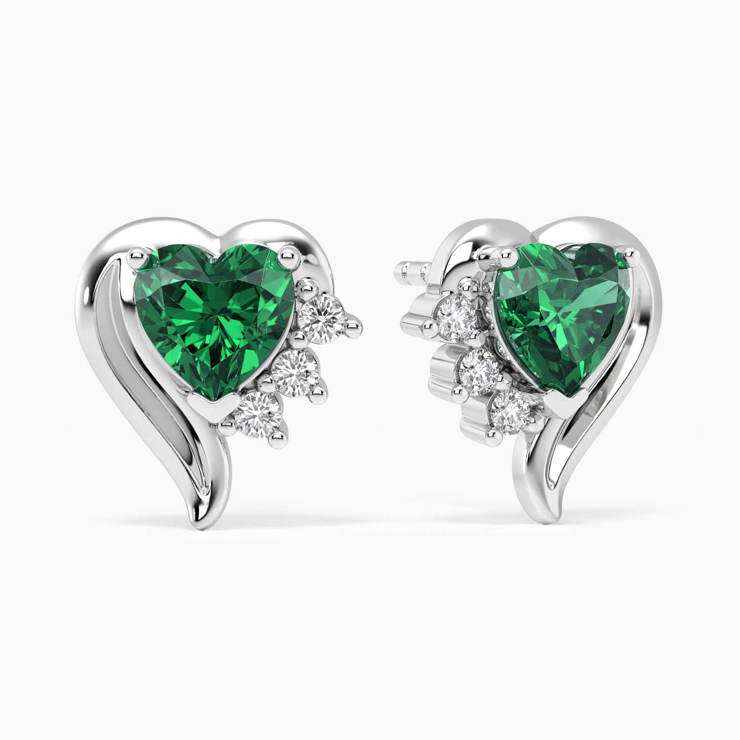 Pair of sterling silver heart-shaped emerald stud earrings with sparkling accent stones.