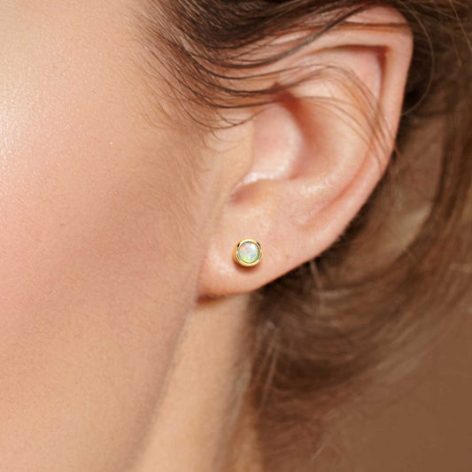 model featuring opal earirngs gold