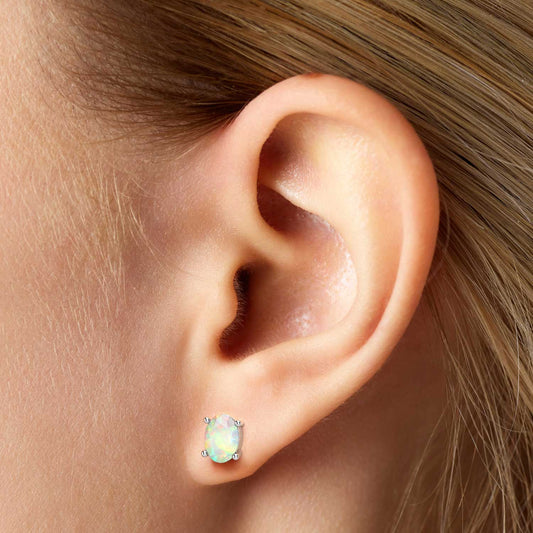 model featuring silver opal earrings