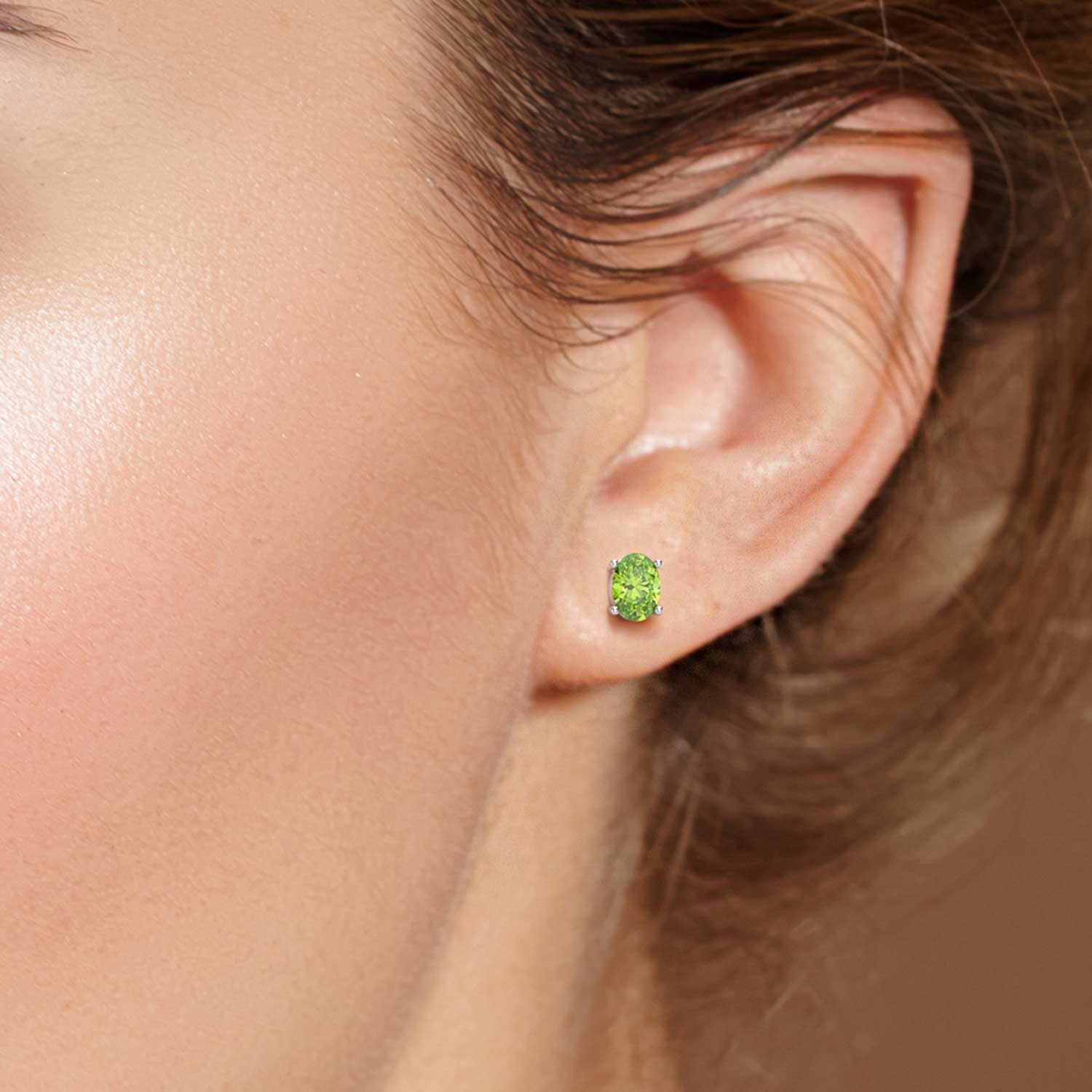 Model wearing Oval Silver Peridot Earrings in Sterling Silver