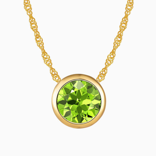 Bezel set round peridot necklace in 18K gold with a sparkling natural gemstone, perfect for August birthstone gifts.