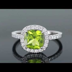 Video thumbnail of Cushion Cut Peridot Ring in Sterling Silver, featuring a vibrant peridot gemstone with a halo of diamond alternatives.