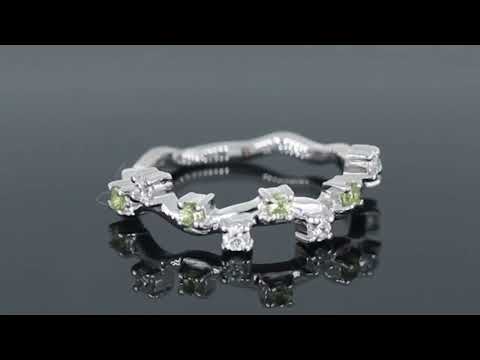 Video preview of a silver peridot ring with a celestial design, accented by white zirconia stones.