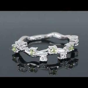 Video preview of a silver peridot ring with a celestial design, accented by white zirconia stones.