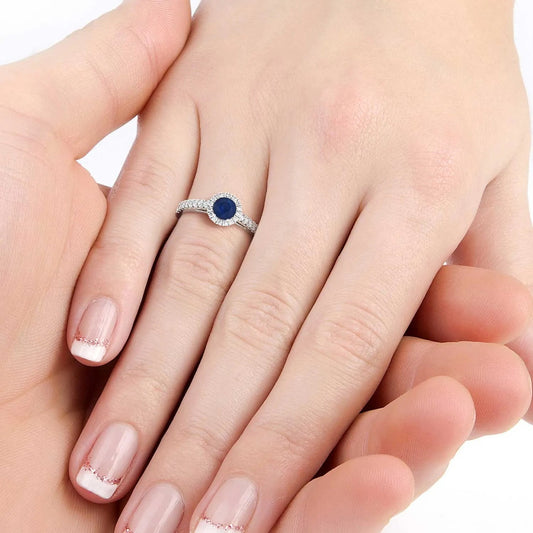 Round cut sapphire ring with halo CZ accents